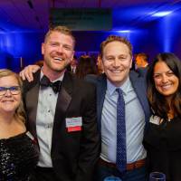 Guests posing at a table in the Laker Lounge